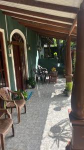 an outdoor patio with benches and a building at Mango paradise sigiriya in Dambulla