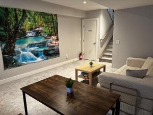 a living room with a painting of a waterfall at Nature Home Near Downtown and 17th Avenue in Calgary