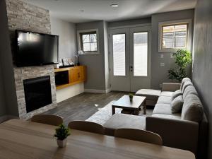 a living room with a couch and a fireplace at Nature Home Near Downtown and 17th Avenue in Calgary