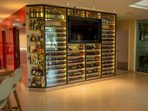 a room with a large display of wine bottles at ibis Vitoria da Conquista in Vitória da Conquista