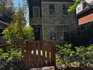 a wooden bench in front of a house at Nature Home Near Downtown and 17th Avenue in Calgary