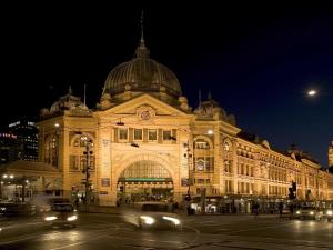 a large building with cars driving past it at night at ibis Budget - Melbourne CBD in Melbourne