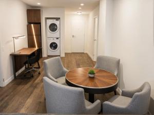 a living room with a table and chairs and a washing machine at Urban Chic residence in Central LA in Los Angeles +16 photos