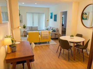 a living room with a table and yellow chairs at Urban Chic residence in Central LA in Los Angeles +16 photos