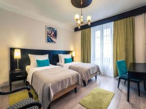 a hotel room with two beds and a piano at Mercure Belgrade Excelsior in Belgrade +120 photos