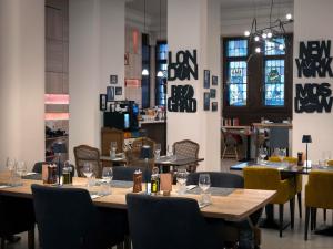 a dining room with wooden tables and chairs at Mercure Belgrade Excelsior in Belgrade