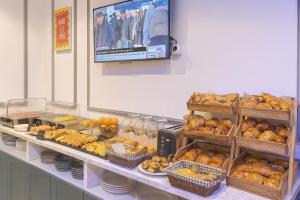 a display case in a bakery with different types of bread at Hotel Arc Paris Porte d'Orléans in Montrouge