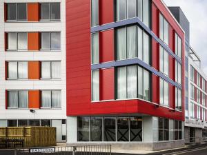 a red and white building on a street at Mercure Bridgwater in Bridgwater