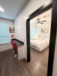 a bedroom with a mirror and a bed and a desk at Contemporary Comfort Near The Woodlands in Spring +35 photos