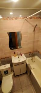a bathroom with a toilet and a sink and a tub at Рахмет in Petropavlovsk +12 photos
