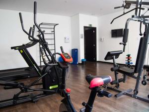 a gym with several exercise bikes in a room at Hotel 3 Rios Plaza in Três Rios +58 photos