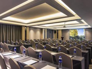 a conference room with tables and chairs and bottles of water at Mercure Chengdu Downtown Hotel in Chengdu