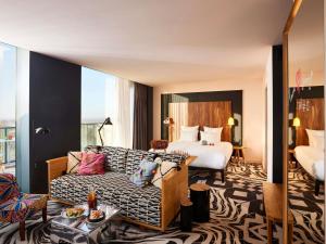 a hotel room with a couch and a bed at Mama Shelter Belgrade in Belgrade +158 photos