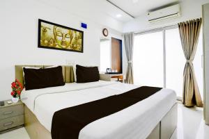 Un dormitorio con una cama grande en una habitación. en Collection O Viviana Mall Thane West Formerly Athithi Stays, en Thane
