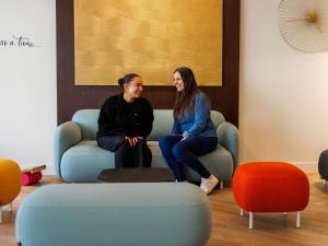 two women sitting on a couch in a room at Adagio Nice Centre in Nice +157 photos