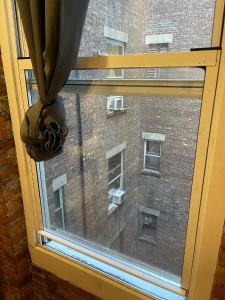 a window with a view of a brick building at Nest Aparthotel Broadway in New York