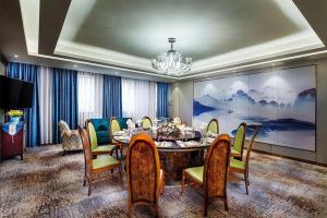 une salle à manger avec une table et des chaises dans l'établissement Xian Empress Hotel, à Xi'an