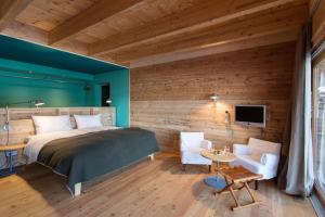 a bedroom with a bed and a wooden wall at Alpenlofts in Bad Gastein