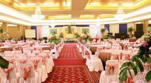 a banquet hall with white tables and chairs at Danau Toba Hotel International in Medan +123 photos