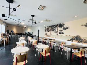 a restaurant with tables and chairs in a room at Aparthotel Adagio Marseille Timone in Marseille