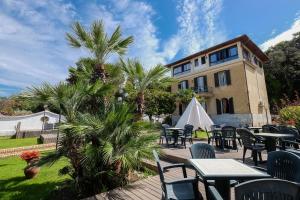 a patio with tables and chairs in front of a building at Antica Villa in Gaeta