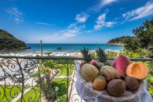 a bowl of fruit sitting on a balcony overlooking the beach at Antica Villa in Gaeta