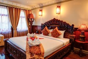 a bedroom with a large bed in a room at Okay Boutique Hotel in Phnom Penh