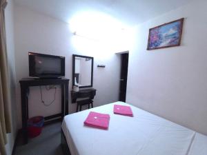 a hotel room with a bed and a television at Hotel Bumimas in Kuantan