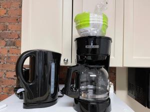 a black coffee maker sitting on top of a counter at Nest Aparthotel Broadway in New York