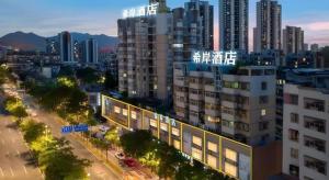 a view of a city at night with tall buildings at Xana Lite Jiangmen Yingbin West in Jiangmen