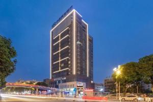 a tall building in a city at night at Fortune Hotel Ningde in Ningde