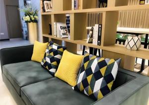 un canapé noir avec des coussins jaunes et noirs dessus dans l'établissement City Comfort Inn Wuhan Wangjiawan Longyangcun Metro Station, à Wuhan