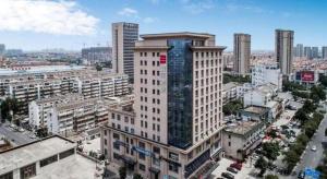 eine Luftaufnahme eines großen Gebäudes in einer Stadt in der Unterkunft Echarm Hotel Yangzhou Jiangdu Jinyin Plaza in Zhanggang