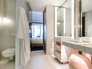 a white bathroom with a sink and a toilet at Sofitel Mexico City Reforma in Mexico City