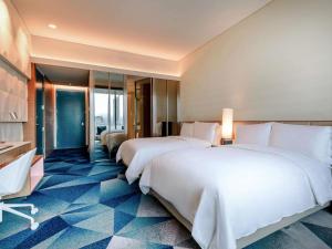 a hotel room with two beds and a television at Sofitel Mexico City Reforma in Mexico City +274 photos