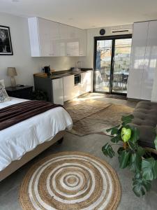 a bedroom with a large bed and a kitchen at Three Waves in Ballito