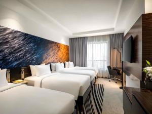 Ένα ή περισσότερα κρεβάτια σε δωμάτιο στο Novotel Makkah Thakher City