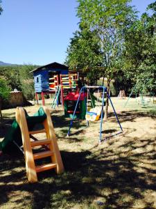 a park with a playground with slides and swings at Il Bettarello in Roccastrada