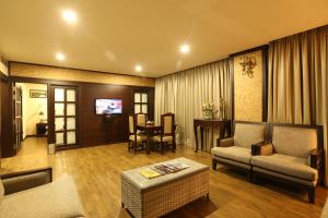 a living room with a couch and a table at Hotel Atithi in Guwahati
