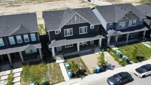 an overhead view of a house with cars parked in front at Peaceful Homes - Elegant 2 Bedroom Suite in Calgary