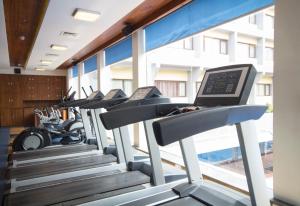 a row of treadmills in a gym at Dolphin Hotel in Visakhapatnam