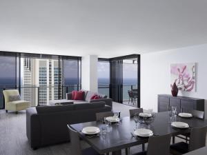 a living room with a couch and a table at Mantra Circle On Cavill in Gold Coast