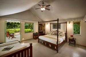 a bedroom with two beds and a ceiling fan at Varawal Leopard Camp in Mori Bera
