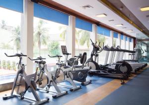a gym with several treadmills and exercise bikes at Dolphin Hotel in Visakhapatnam