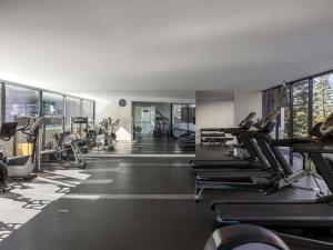 a gym with lots of treadmills and machines at Peppers Broadbeach in Gold Coast
