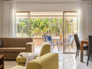 a living room with a couch and a table at Mantra Amphora in Palm Cove