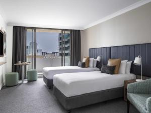 Ένα ή περισσότερα κρεβάτια σε δωμάτιο στο Mantra Chatswood