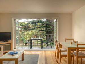 a living room with a sliding glass door to a patio at Mantra Lorne in Lorne