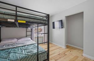 a bedroom with two bunk beds and a television at New 3br home Ready for the Holidays in Dublin