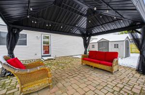 a patio with two chairs and a couch under a black canopy at New 3br home Ready for the Holidays in Dublin